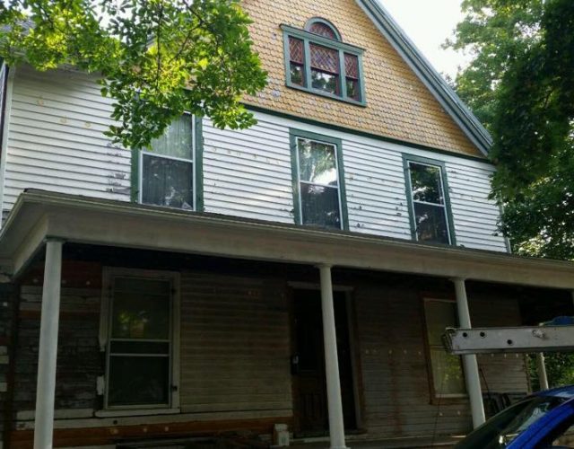 before picture of historic home with cracked and peeling siding