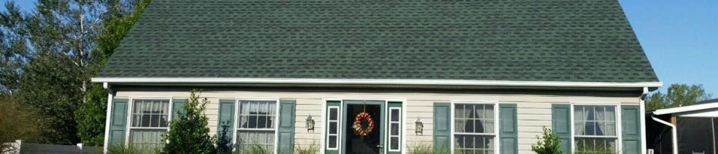 house with new completed green Timberline shingle roof