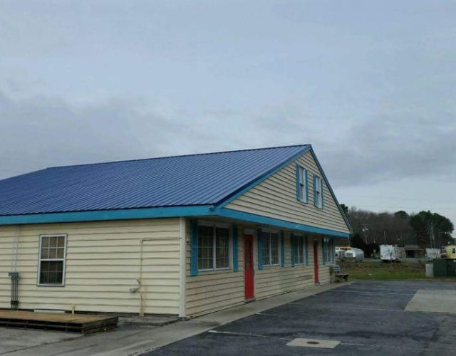 business store front with completed blue master rib metal roof