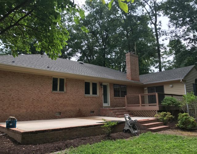 small rancher brick home with new shingle residential roof