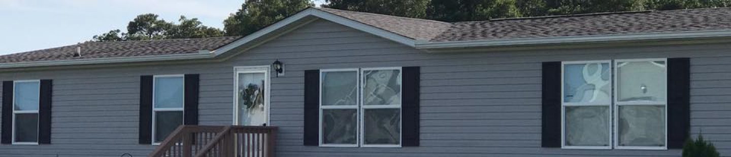 completed gray roof project on mobile home