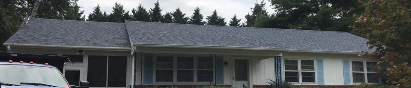one story home with completed black shingle roof